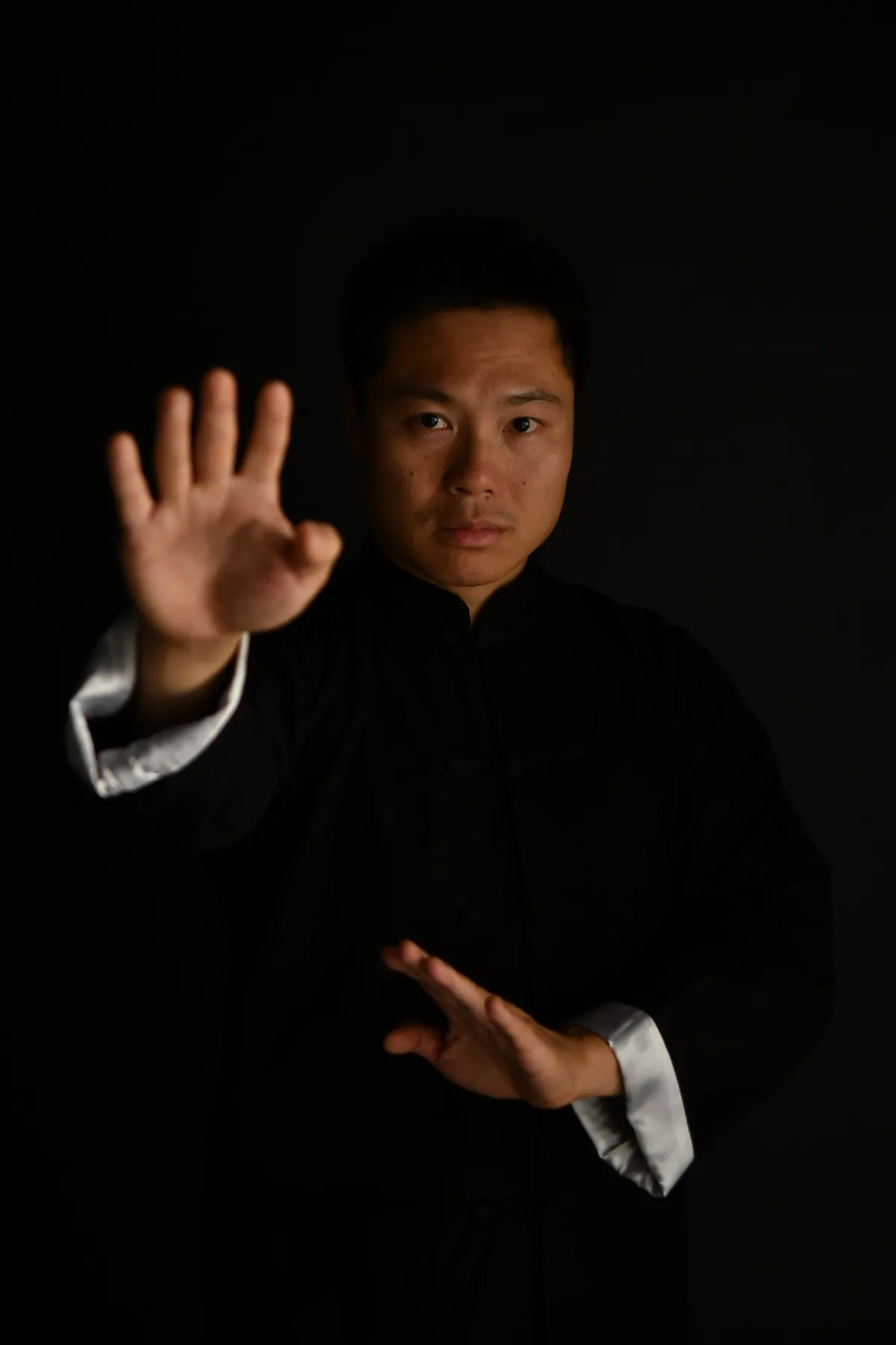 Master Leo Au-Yeung in a still Wing Chun guard in the studio